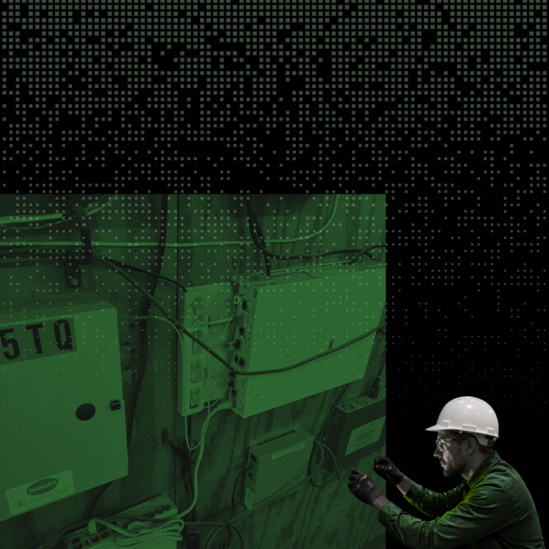 Technician inspecting network equipment and cabling for hidden infrastructure issues in a warehouse technology project.