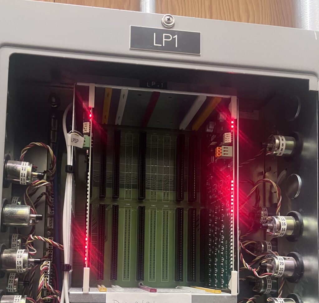 Labeled IT infrastructure wiring inside a control panel before office equipment and room changes
